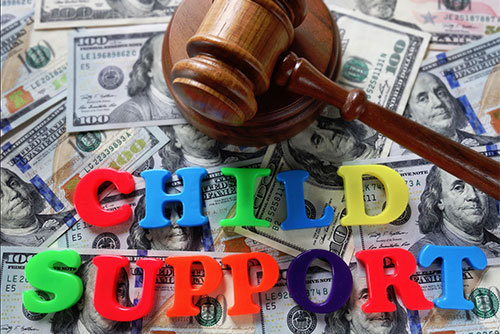 child support letters with gavel and cash