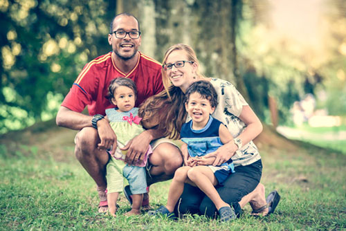 Interracial couple with two children in a park
