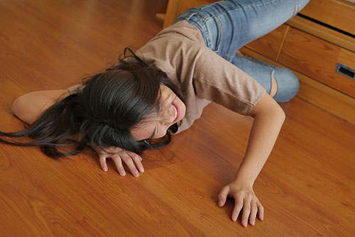 Woman laying on floor after a slip and fall